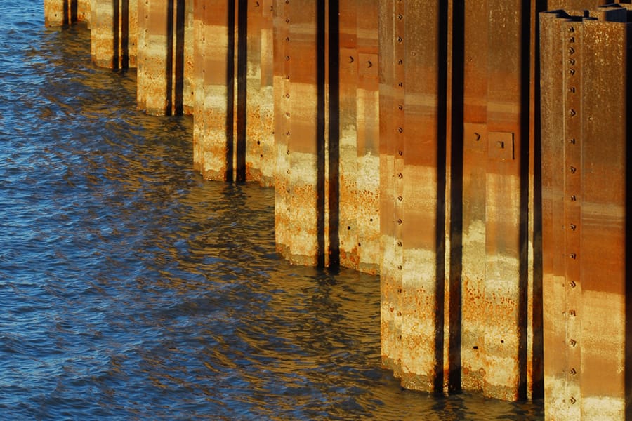 Steel sheet piles installed along waterfront in marine or riverbank zone