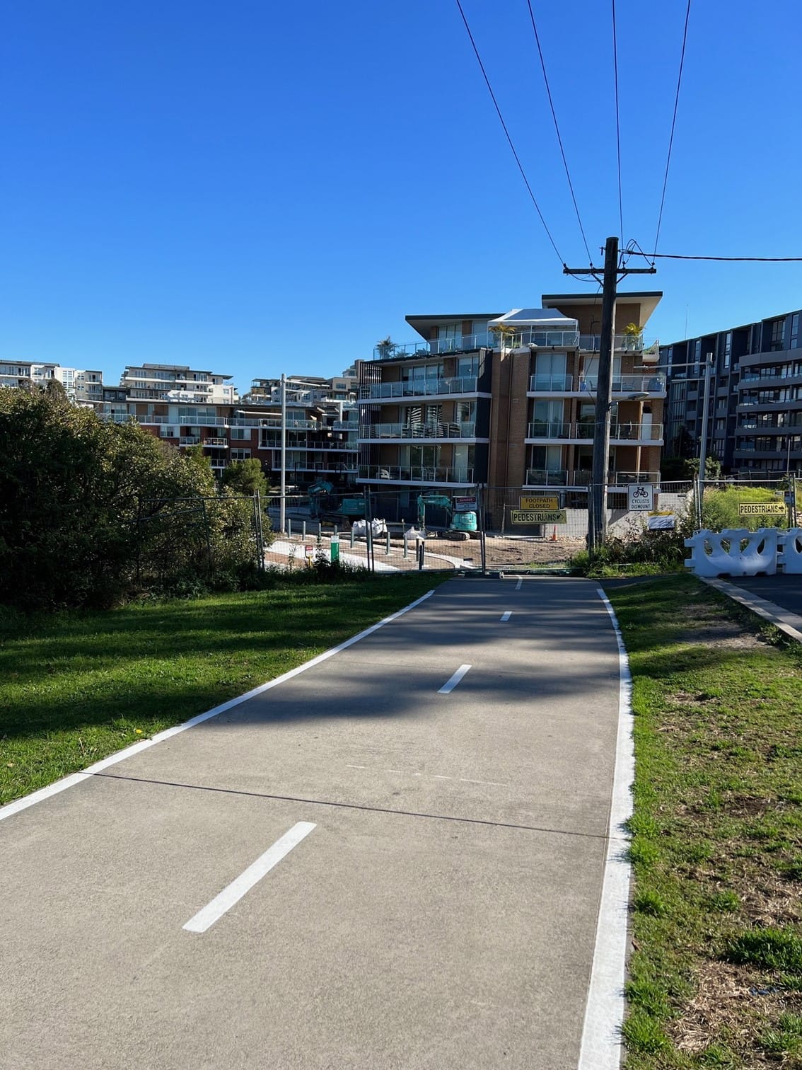 Urban shared path in residential area with modern apartment buildings