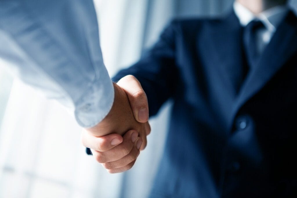 Close-up of a handshake between two business professionals.